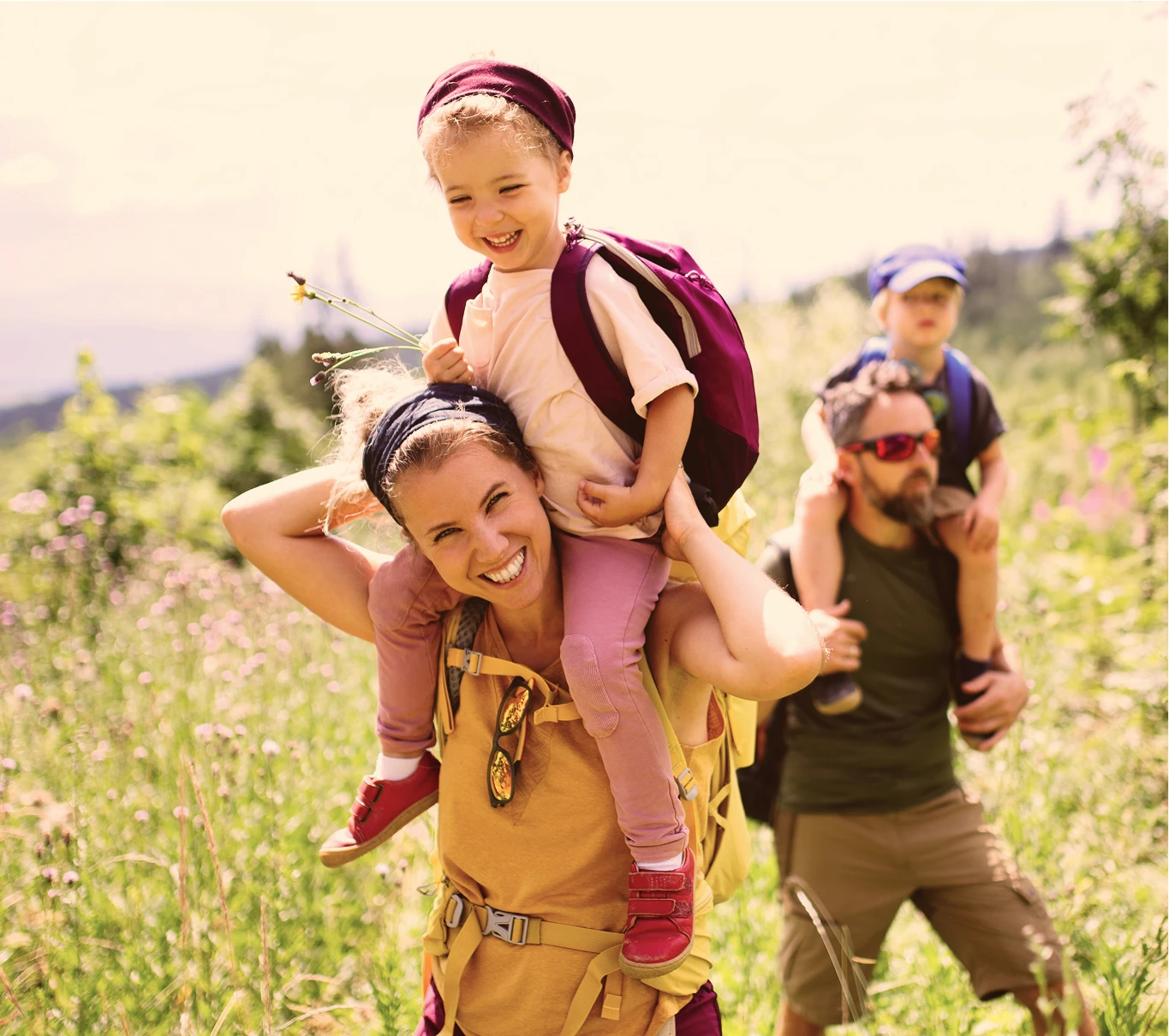 Man and woman hiking with their children